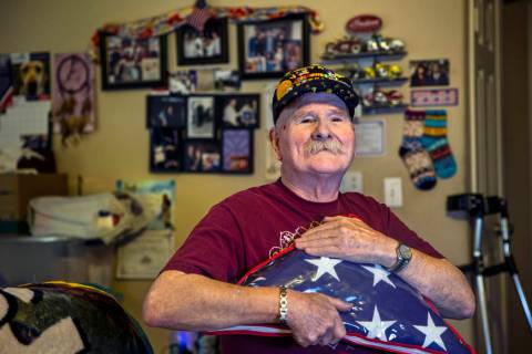 Ret. Chief Master Sgt. Clifford Smith, a Vietnam War veteran, holds a military burial flag in h ...