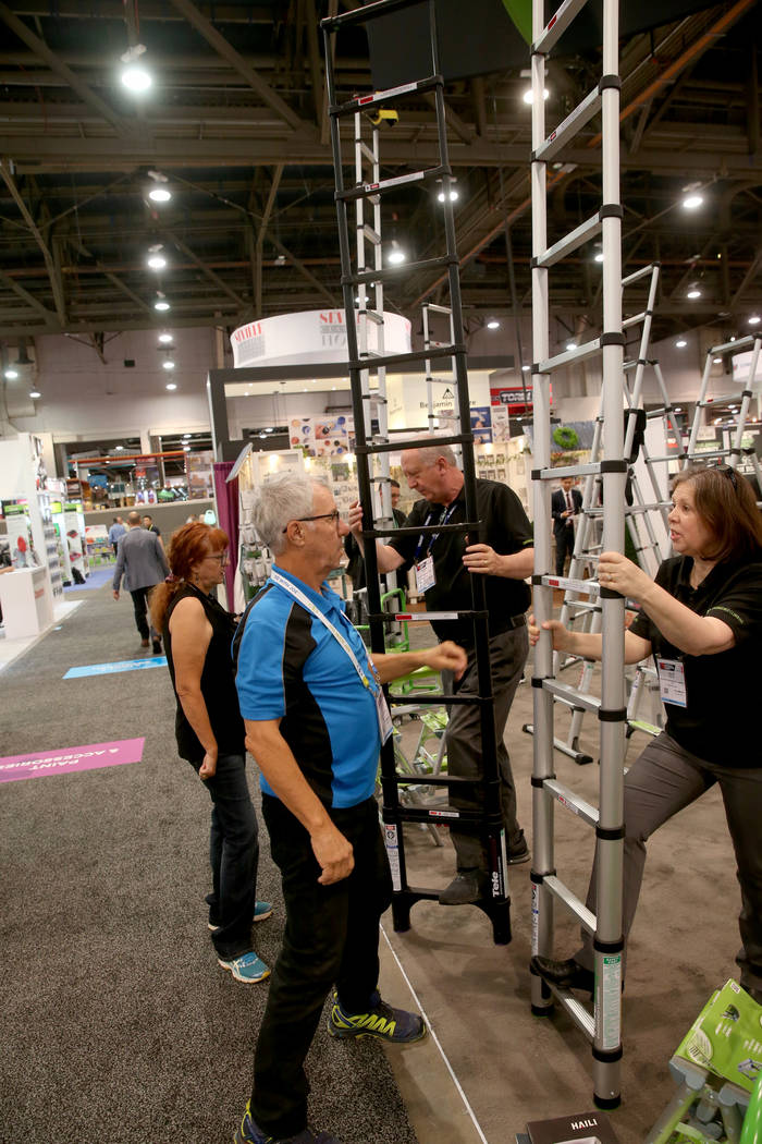 Sheila and George Butler of Mesa, Arizona check out collapsible ladders with Shawn and Julie Re ...