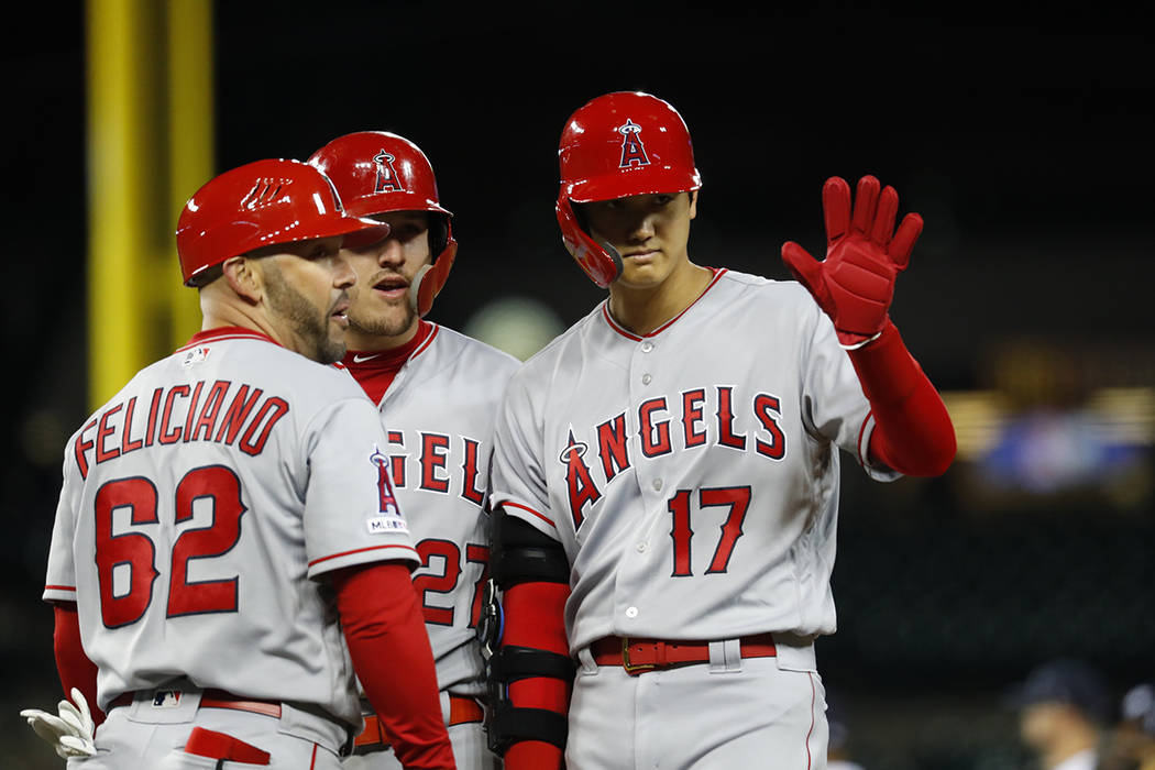 Los Angeles Angels' Shohei Ohtani (17) waves to fans after walking in the ninth inning of a bas ...