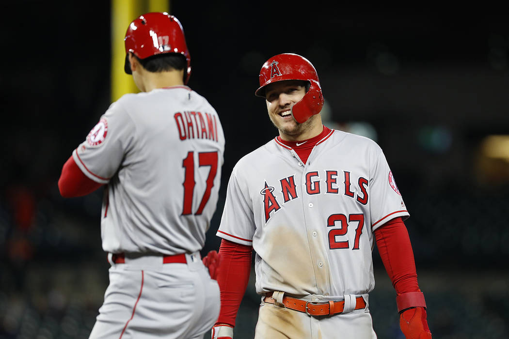 Los Angeles Angels' Mike Trout (27) smiles at Shohei Ohtani (17) in the ninth inning of a baseb ...