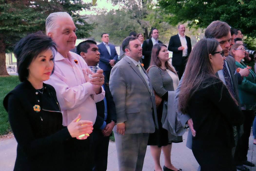 Gov. Steve Sisolak and his wife, Kathy, attend a candlelight remembrance for North Las Vegas As ...