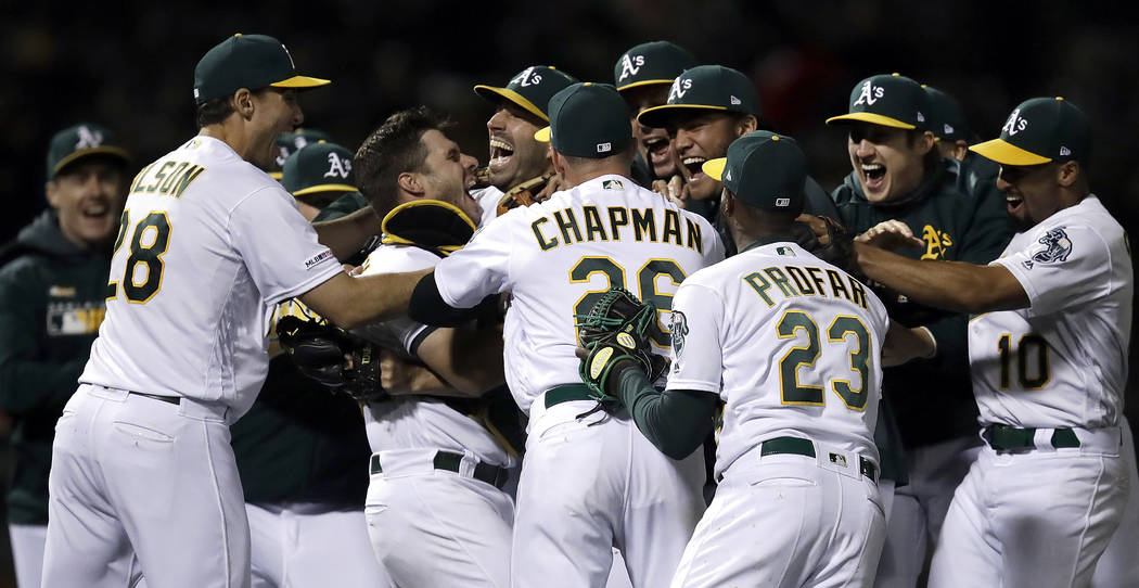 Oakland Athletics' Mike Fiers is mobbed by teammates after pitching a no hitter against the Cin ...
