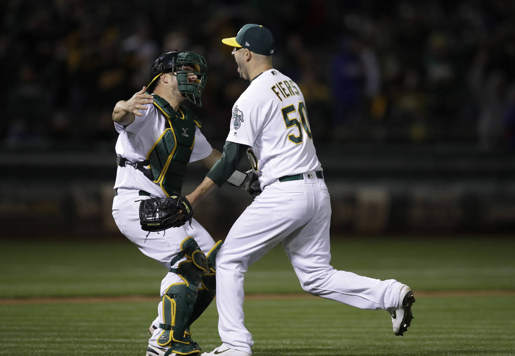 Oakland Athletics' Mike Fiers, right, celebrates with catcher Josh Phegley after pitching a no ...
