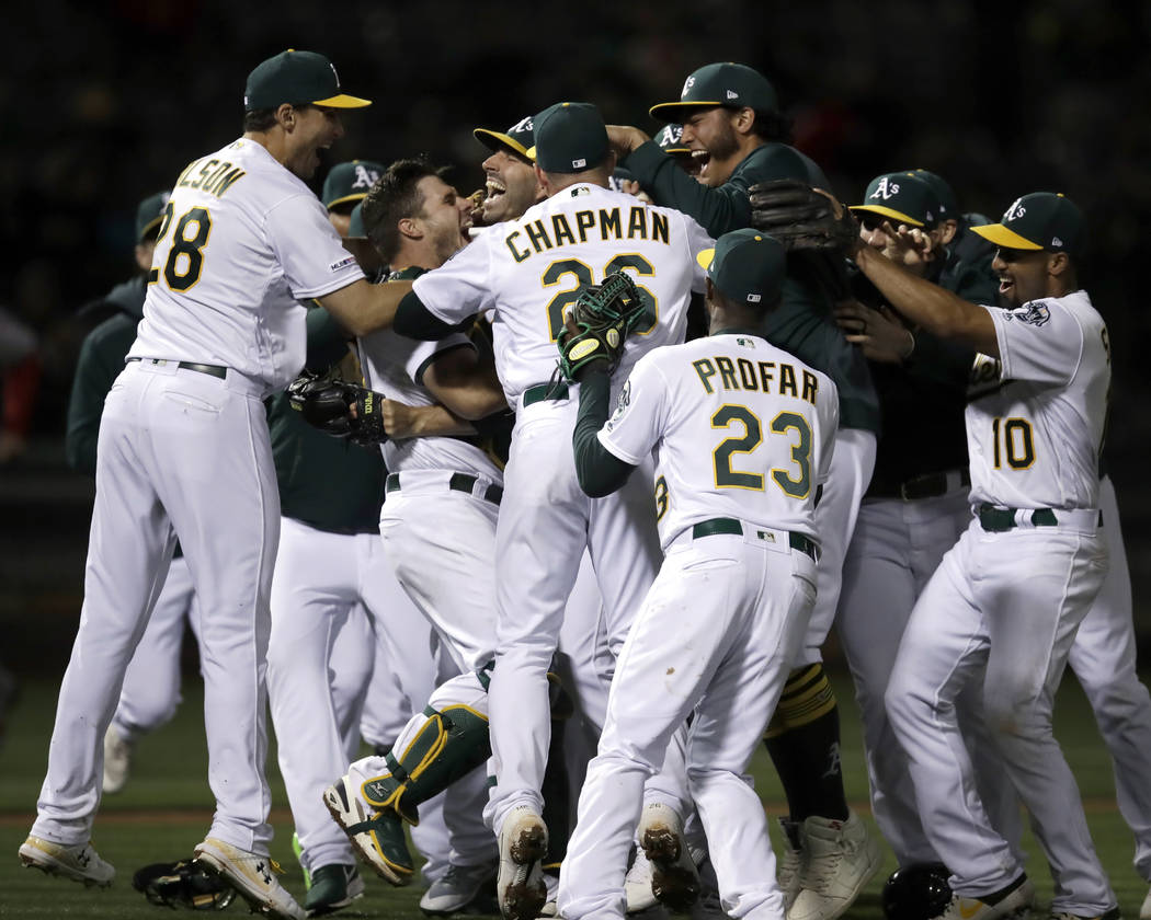 Oakland Athletics' Mike Fiers is mobbed by teammates after pitching a no hitter against the Cin ...