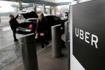 A sign marks a pick-up point for the Uber service at LaGuardia Airport in New York on March 15, ...