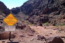 A temporary closure sign warns visitors at the Goldstrike Canyon trail in Lake Mead National Re ...