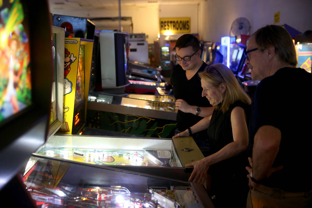 Sherry Smith, her son Elvis, 23, and husband Duane of Lancaster, Pennsylvania, play a pinball m ...