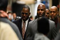 Musician R. Kelly arrives at the Daley Center for a hearing in his child support case Wednesday ...