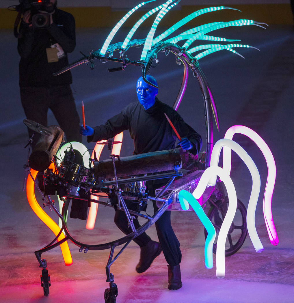 A member of Cirque du Soleil's Blue Man Group performs on the second intermission during an NHL ...