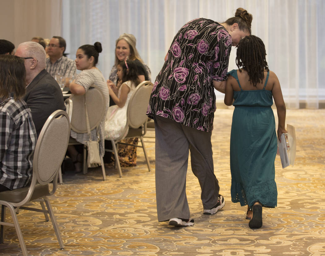 Award winner Ma’Raya Gilbert, right, a third grader at Silver Sands Montessori, walks ba ...