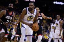 Houston Rockets' James Harden, left, and Golden State Warriors' Kevin Durant (35) react to a re ...