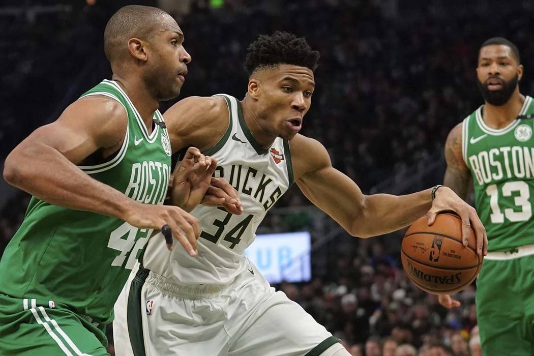 Milwaukee Bucks' Giannis Antetokounmpo tries to drive past Boston Celtics' Al Horford during th ...