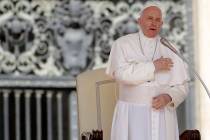 Pope Francis does the sign of the cross during his weekly general audience, in St. Peter's Squa ...