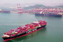A container ship sails off the dockyard in Qingdao in eastern China's Shandong province Wednesd ...