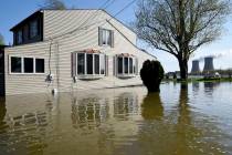In this Wednesday, May 8, 2019 photo, a home surrounded by water on Lakeshore Dr. in the south ...