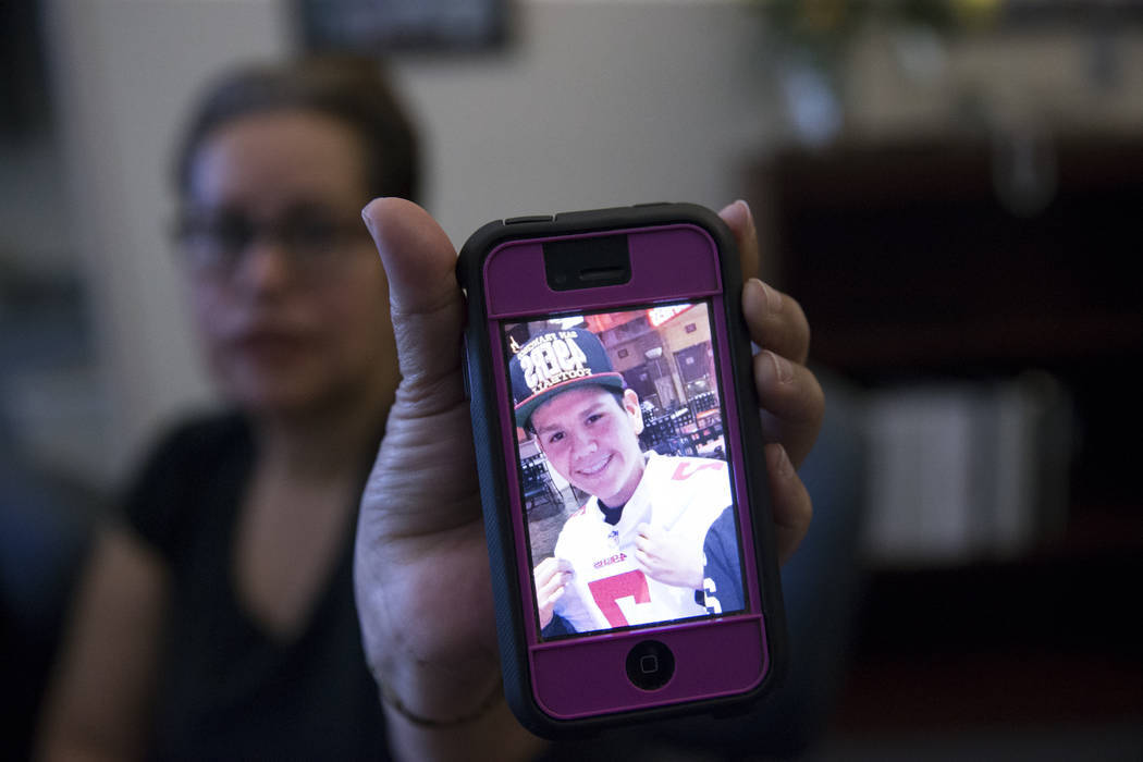 Edith Guzman shows a picture of her son Jose de Jesus Alatorre Guzman, who was shot and killed ...