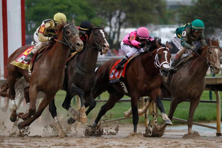 In this May 4, 2019, file photo, Flavien Prat on Country House, left, races against Luis Saez o ...