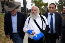 Rabbi Yisroel Goldstein, center, arrives for a news conference at the Chabad of Poway synagogue ...
