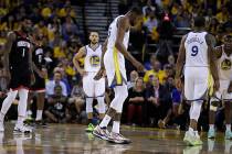 Golden State Warriors' Kevin Durant, center, limps off the court during the second half of Game ...