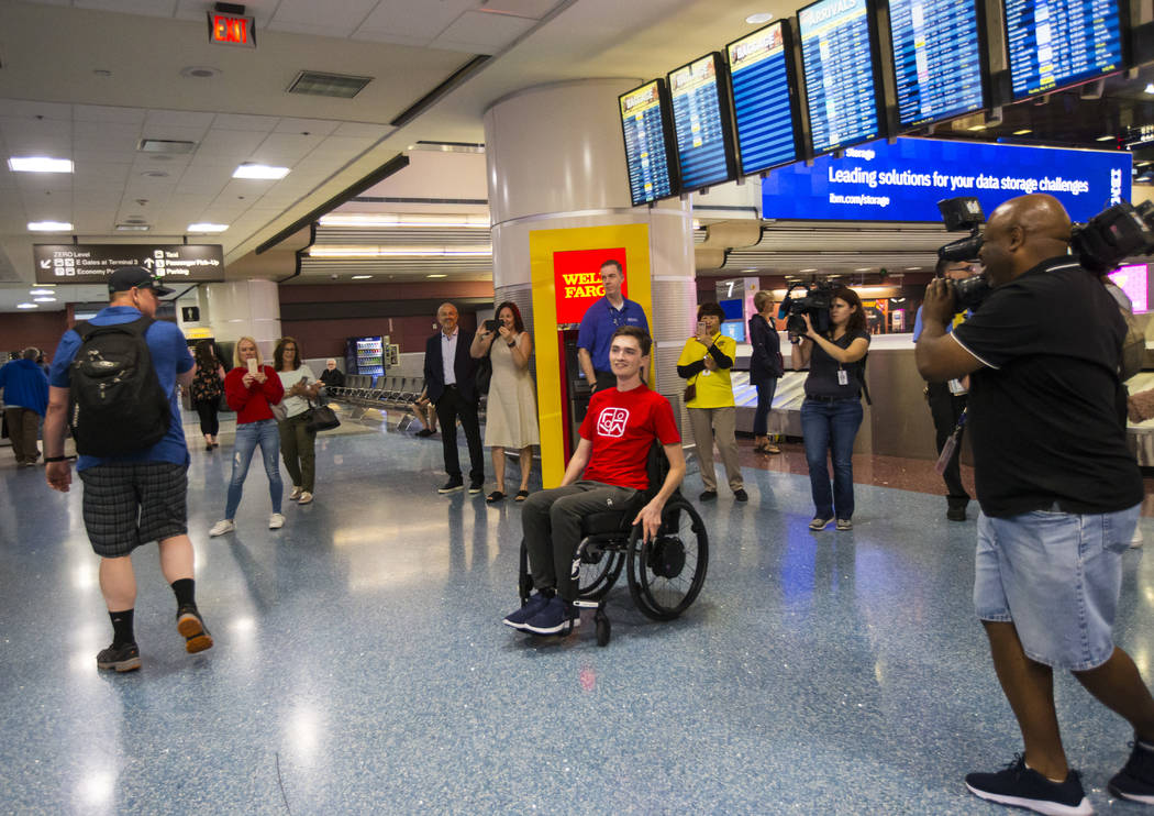 Faith Lutheran senior Mark Wilbourne, in red, reacts to a welcome party at McCarran Internation ...