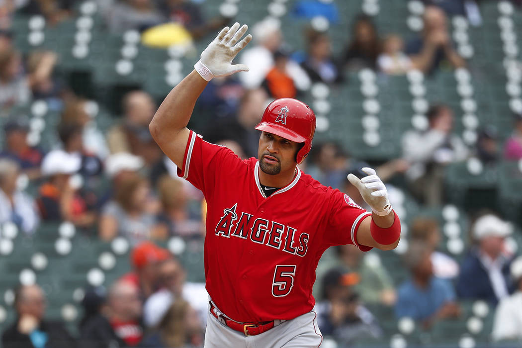 Los Angeles Angels' Albert Pujols tosses his bat after hitting a solo home run in the third inn ...