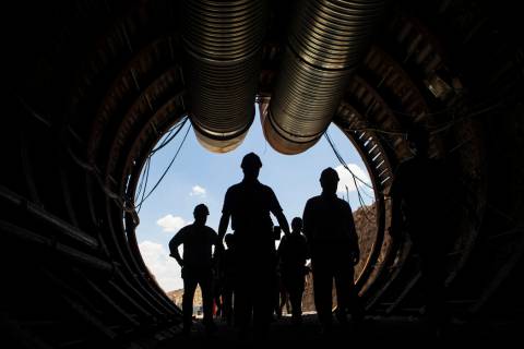 Members of a congressional tour make their way through the south portal of Yucca Mountain near ...