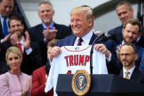 President Donald Trump shows off a Red Sox jersey presented to him during a ceremony welcoming ...