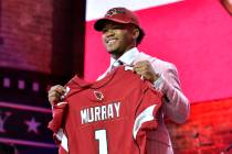 Oklahoma quarterback Kyler Murray holds his up a jersey after the Arizona Cardinals selected Mu ...
