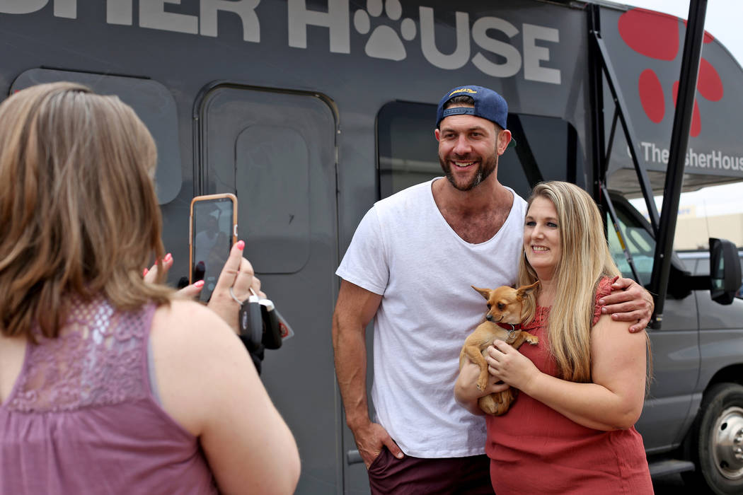 Renne Babiracki, of Oregon, takes a photo with Lee Asher while holding  Penny outside The Asher … | Las Vegas Review-Journal