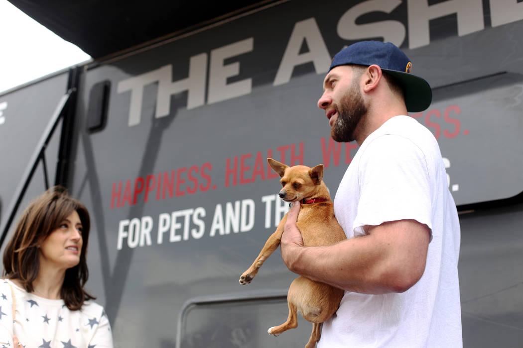 Lee Asher talks to fans while holding Penny outside The Asher House RV in  the parking lot of Ne … | Las Vegas Review-Journal