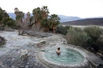 A visitor relaxes in the hot springs of Saline Valley at Death Valley National Park. (J. Emilio ...