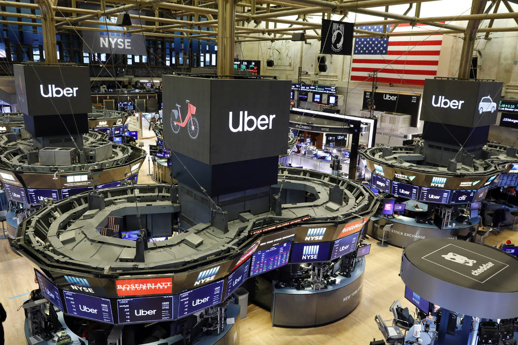 Uber logos top trading posts on the floor of the New York Stock Exchange, Friday, May 10, 2019. ...
