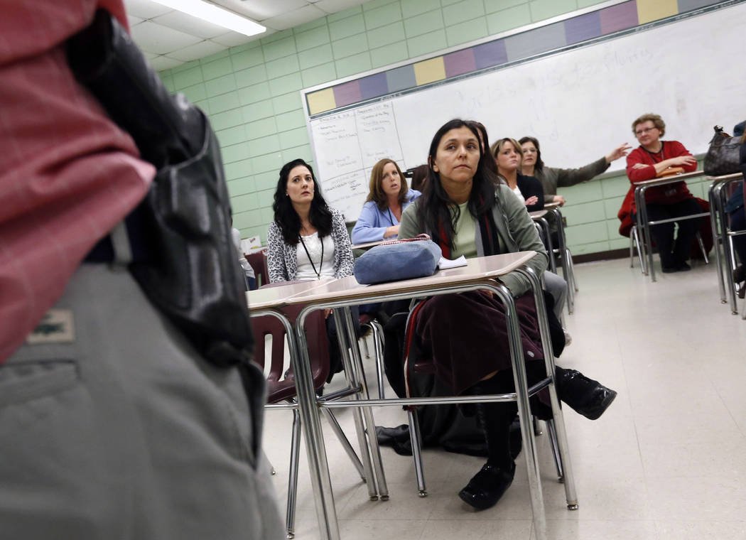 Teacher Astrid Barrios, center, listens March 15, 2013, as Milford police detective Carlos Sous ...