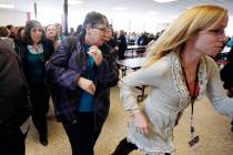 Participants rush out of the cafeteria after hearing gun shots during a lockdown exercise March ...
