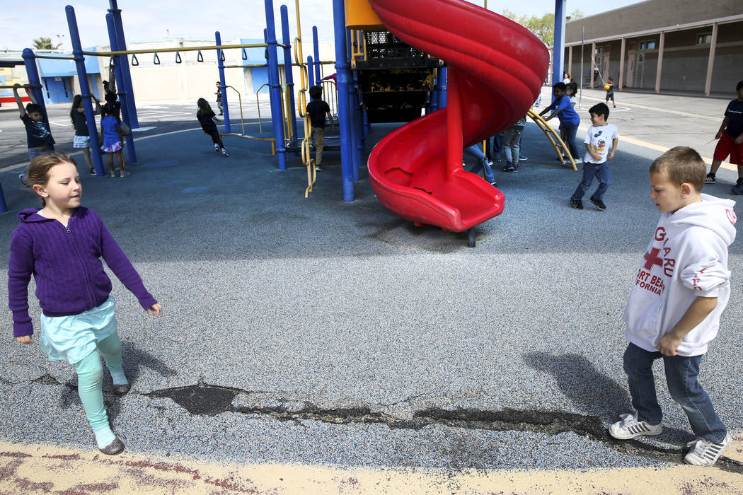 Klarie Fancher and Mason Thomas show damage on their playground at Helen Smith Elementary Schoo ...
