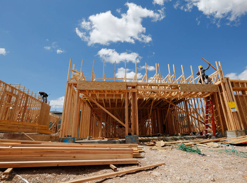 Workers construct houses near the corner of Mesa Park Drive and Hualapai Way in Summerlin, Frid ...