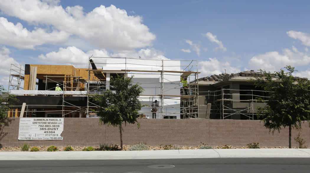 Workers construct houses near the corner of Mesa Park Drive and Hualapai Way in Summerlin, Frid ...