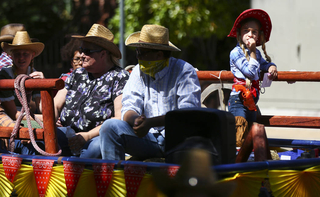 Participants on the Del Sol Academy of the Performing Arts float wear western attire during the ...