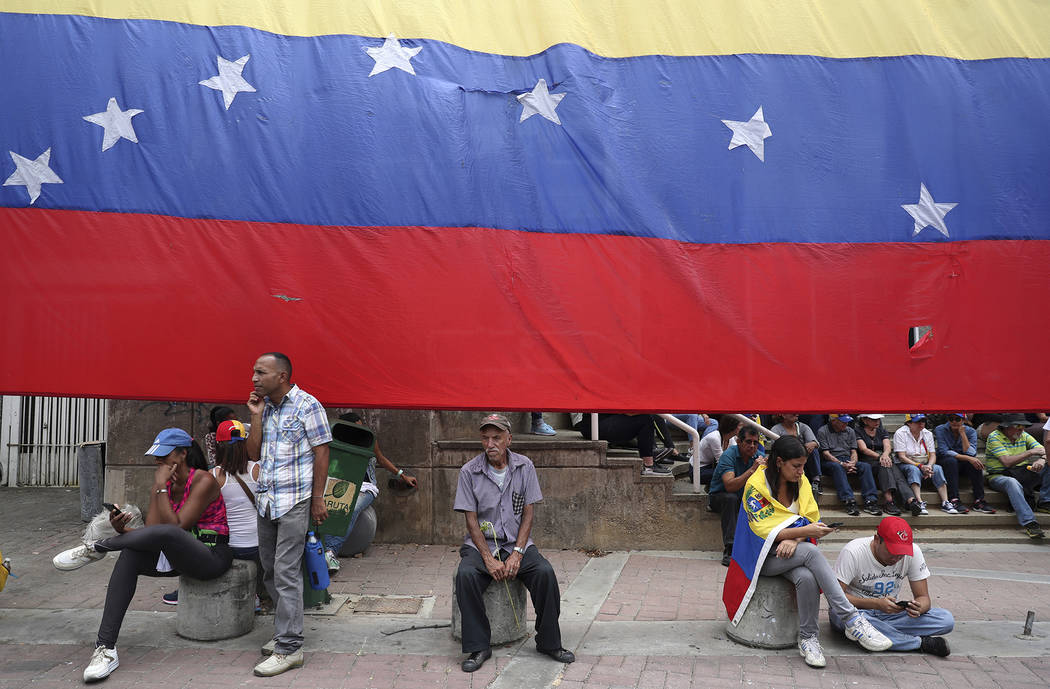 Opponents of the Nicolas Maduro government wait for the arrival of opposition leader Juan Guaid ...