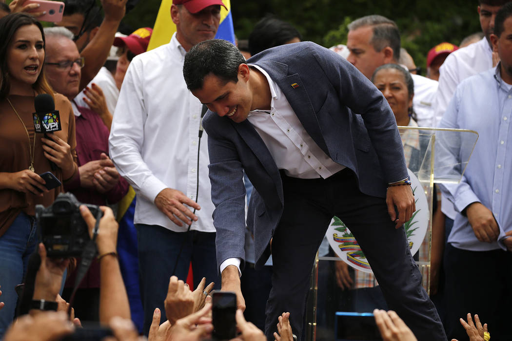 Opposition leader Juan Guaidó greets supporters as he arrives to lead a rally in Caracas, ...