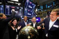 In this Friday, May 10, 2019 file photo, Uber board member Ryan Graves, right, rings a ceremoni ...