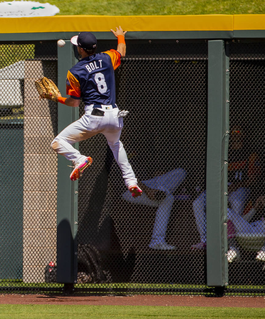 The Aviators Skye Bolt (8) attempts to catch a ball deep in right field hit off the wall by the ...