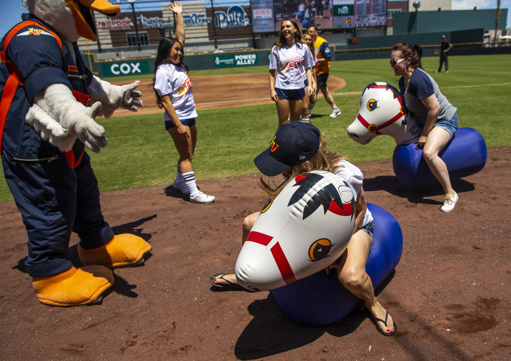 Aviators fans participate in a horse race during a break in the action versus the Tacoma Rainie ...