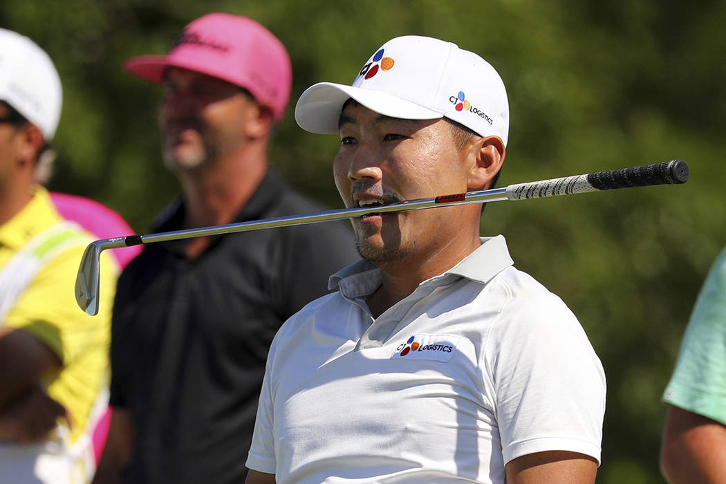 Sung Kang holds his club in his teeth after his shot of the 12th tee n the final round of the B ...