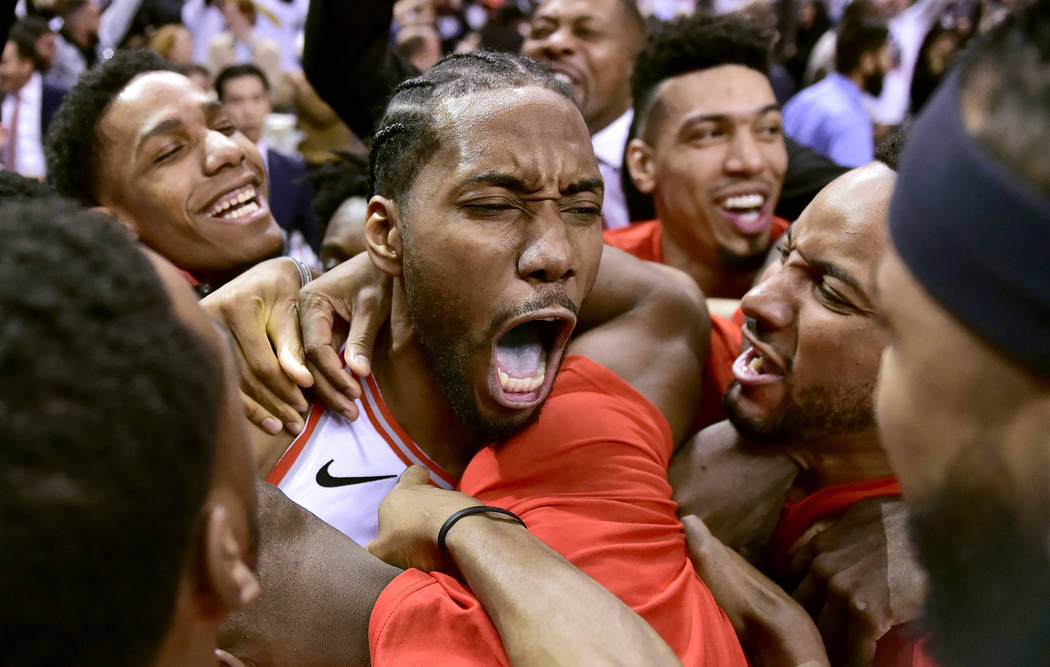 Toronto Raptors forward Kawhi Leonard, center, celebrates his game-winning basket as time expir ...