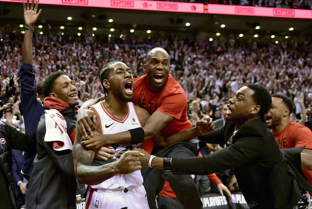 Toronto Raptors forward Kawhi Leonard, second from left, celebrates his game-winning basket as ...