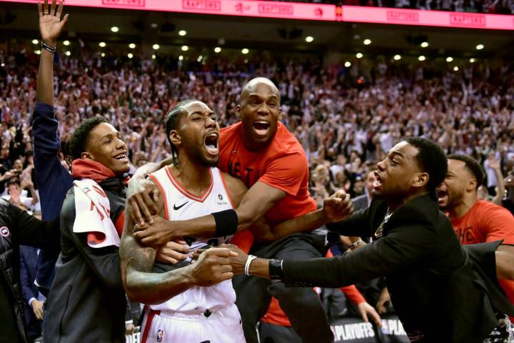 Toronto Raptors forward Kawhi Leonard, second from left, celebrates his game-winning basket as ...