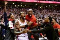 Toronto Raptors forward Kawhi Leonard, second from left, celebrates his game-winning basket as ...