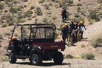 Rescuers carry a sick hiker down Lone Mountain in Las Vegas on Sunday, May 12, 2019. (Las Vegas ...