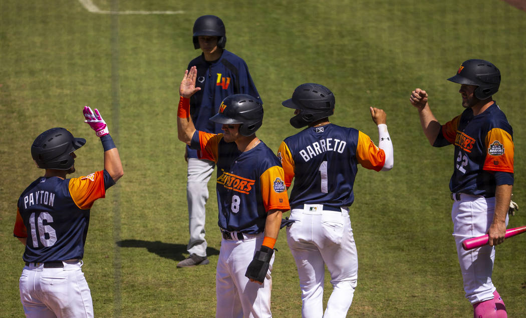 Aviators players celebrate a grand slam late in the game versus the Tacoma Rainiers at the Las ...